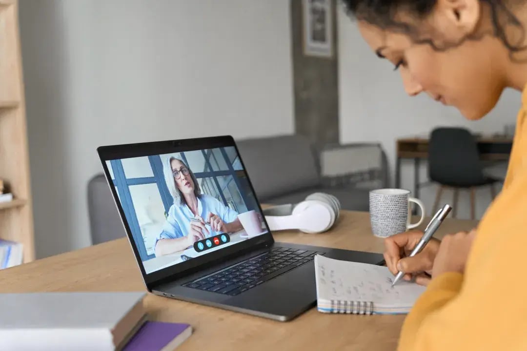 Person watching a video and taking notes