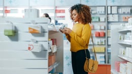 Women reading a product label at a retail store